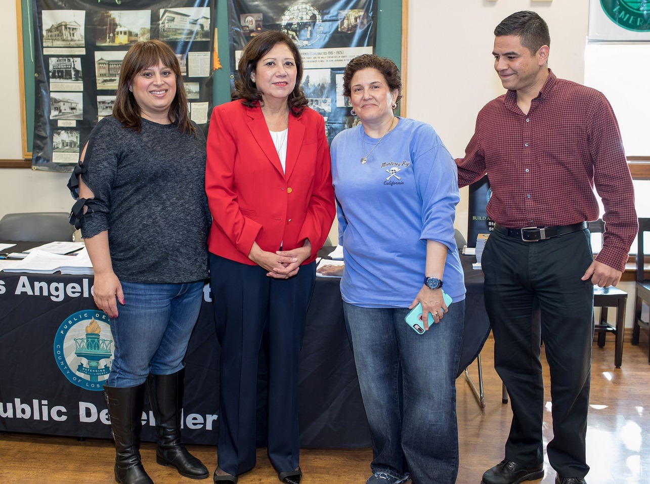 Supervisor Hilda Solis (in red) with paralegals Katty Yasharal (left) and Miriam Singer, and clerk Leonzio Salazar at the event in Highland Park on Nov. 4.