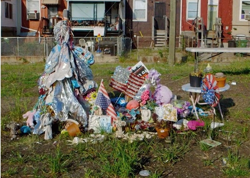 A still from Charm City shows a makeshift memorial for a young woman gunned down in Baltimore, which prompted her brother to vow to destroy his enemy — violence — by working harder to create peace.